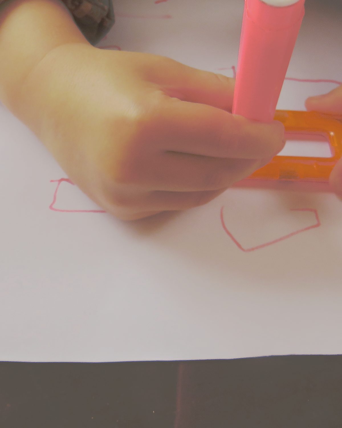 A child's hand at work, focused, unhurried